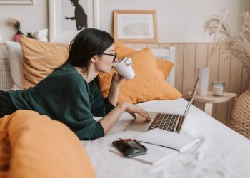 A picture containing indoor, person, wall, computer Description automatically generated