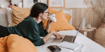 A picture containing indoor, person, wall, computer Description automatically generated